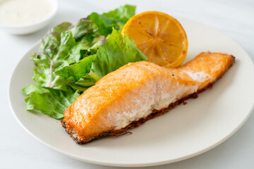 fried salmon steak with lemon and vegetable