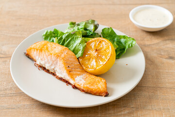 fried salmon steak with lemon and vegetable