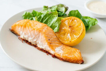 fried salmon steak with lemon and vegetable