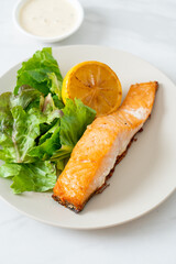 fried salmon steak with lemon and vegetable