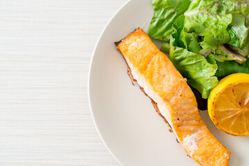 fried salmon steak with lemon and vegetable