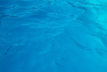 blue water wave texture background. Rippled water. Shiny purple and blue water surface.