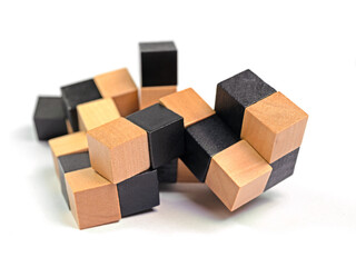 Geduldsspiel aus Holzwürfeln vor weißem Hintergrund