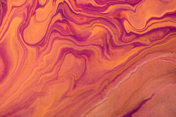 Abstract fluid art background dark purple and orange colors. Liquid marble. Acrylic painting with golden gradient.