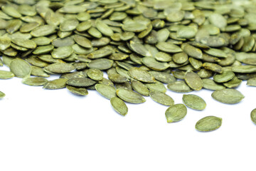 Pile of pumpkin seeds isolated on white background. Organic food, top view.