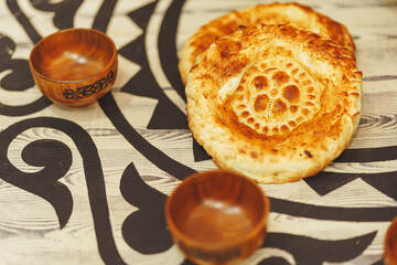 A flatbread is a national Kazakh bread product on the table. Central Asian traditional food on the...