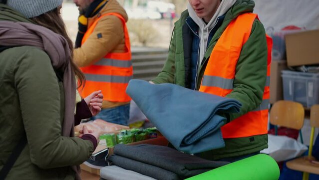 Volunteers distributing blankets and other donations to refugees on the Ukrainian border.