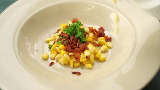 corn soup with crispy bacon on plate