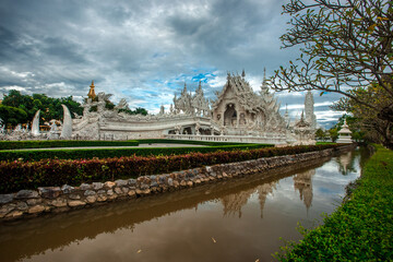 Fototapeta premium background Wat Rong Khun The White Temple and pond with fish, in Chiang Rai, Thailand