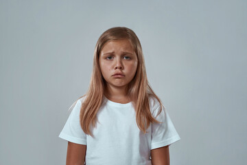 Partial image of sad little girl looking at camera