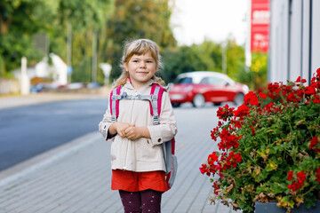 Cute little preschool girl going to playschool. Healthy toddler child walking to nursery school and...