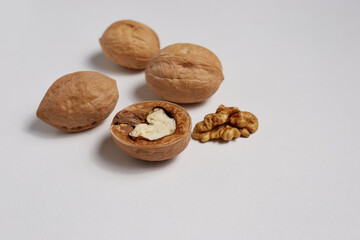 In the photo, a group of walnuts on a white background, delicious food