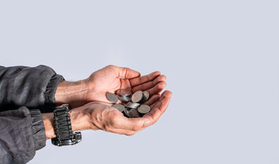 Fototapeta premium Hands with several coins in isolated background, Close up of hand with several coins, currency savings concept