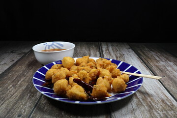 Traditional deep fried Bean cake (Bayia) serving on the plate. Famous Indian snack concept.