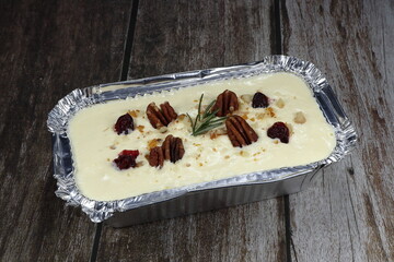 Traditional classic carrot cake serving in the foil tray. Famous sweet dessert menu in bakery shop. 