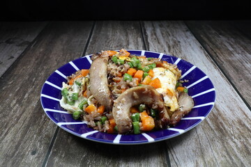 Traditional fried rice with mixed vegetable and grilled pork serving on the plate. Famous special menu in Asia restaurant. 