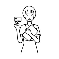 立って書類とカードを手に持つエステ店員・接客・受付の女性