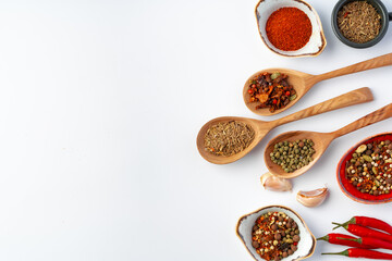 Variety of cooking spices on white background.