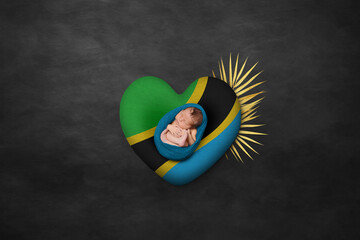Newborn portrait on heart in color of national flag. Photography peace concept. Tanzania