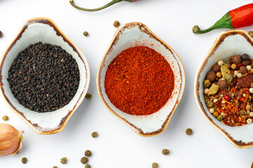 Bowls with various spices on white background