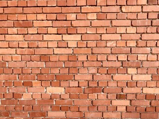 Obraz premium A wall made of red old bricks 