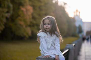 Beautiful little child girl walking in a park. High quality photo