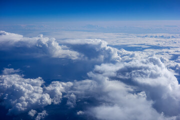 Fototapeta na wymiar White fluffy clouds in a bright blue sky