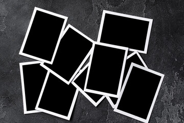 Paper photo frames with blank space on gray textured background