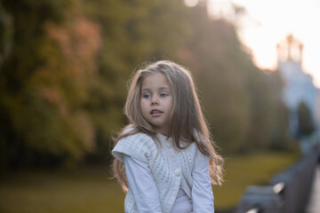 Beautiful little child girl walking in a park. High quality photo