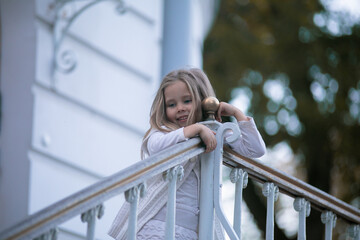 Beautiful little child girl walking in a park. High quality photo