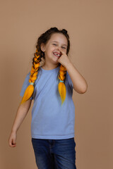 Caucasian naughty small girl smiling shining picking nose with finger looking at camera having...