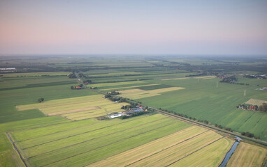 Naklejka premium Agricultural landscape of Friesland, one of the northern provinces of the Netherlands - Friesland from above - Local farm with solar panels on roof