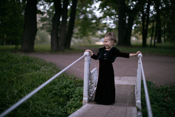 Beautiful little child girl walking in a park. High quality photo