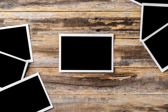 Blank photo frames for your photos on wooden background