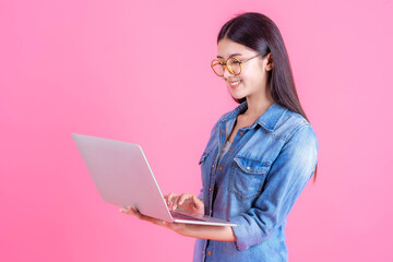 lifestyle beautiful Asian business young woman using laptop computer for online home office isolated on pink background with copy space - online shopping and online banking concept