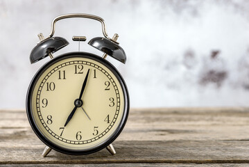 Retro alarm clock on wooden background
