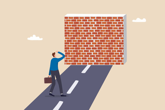 Business barrier, obstacle or difficulty, road block or career struggle, trouble or problem to be solved, prohibited or dead end concept, confused businessman walk on the road to brick wall barrier.