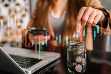 Female hand puting coins in glass for saving money. concept finance and accounting in the home.
