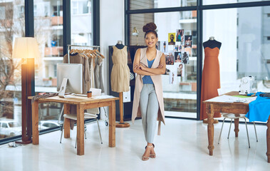 Turn your hobby to something that brings you funds. Portrait of a young fashion designer posing with her arms crossed in her workshop.