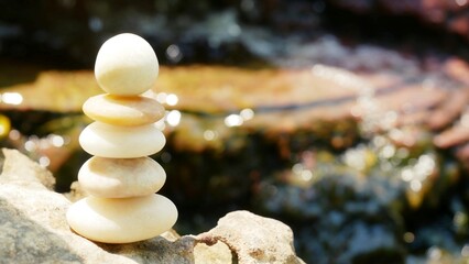 The Balance Stones are stacked as pyramids in a soft natural bokeh background, representing the...