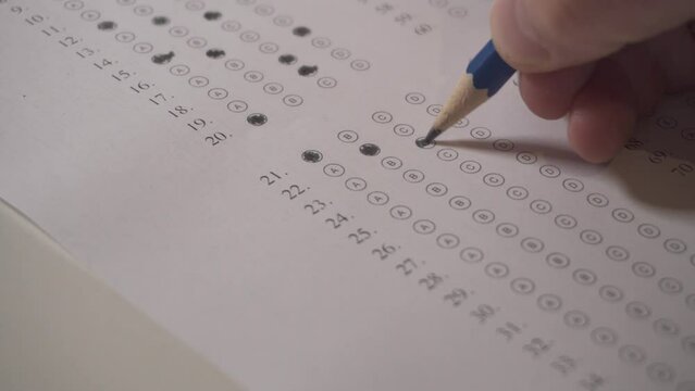 Hand Of A Person On Exam Colors Right Answers With A Pencil. Close up