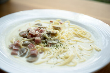 Spaghetti Carbonara with ham mushroom Cream Sauce Italian food selective focus close up in white dish