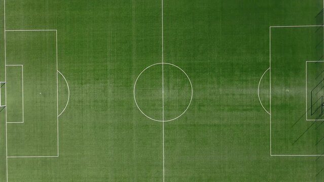 Top view of football or soccer field with green grass and borders lines, top view