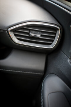 Close up shot of a modern car air vents on the dashboard.