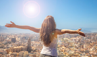 happy woman arms raised in Malaga- Andalusia,  Spain