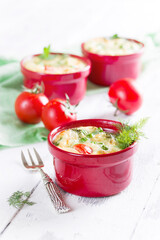 Baked frittata with tomatoes in red pot