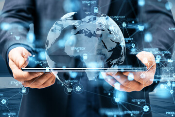 Close up of businessman hands holding pad with abstract digital logistics, delivery and transportation hologram with globe and network on blurry dock background. Double exposure.