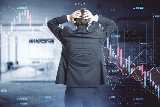 Back view of stressed out businessman looking at abstract downward forex chart on blurry office interior background. Crisis, finance and collapse concept. Double exposure.