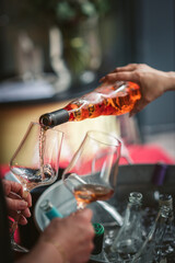 pouring rosé wine into a glass at a wine tasting