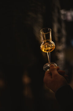 Hand With A Glass Of Grappa Wine At A Tasting